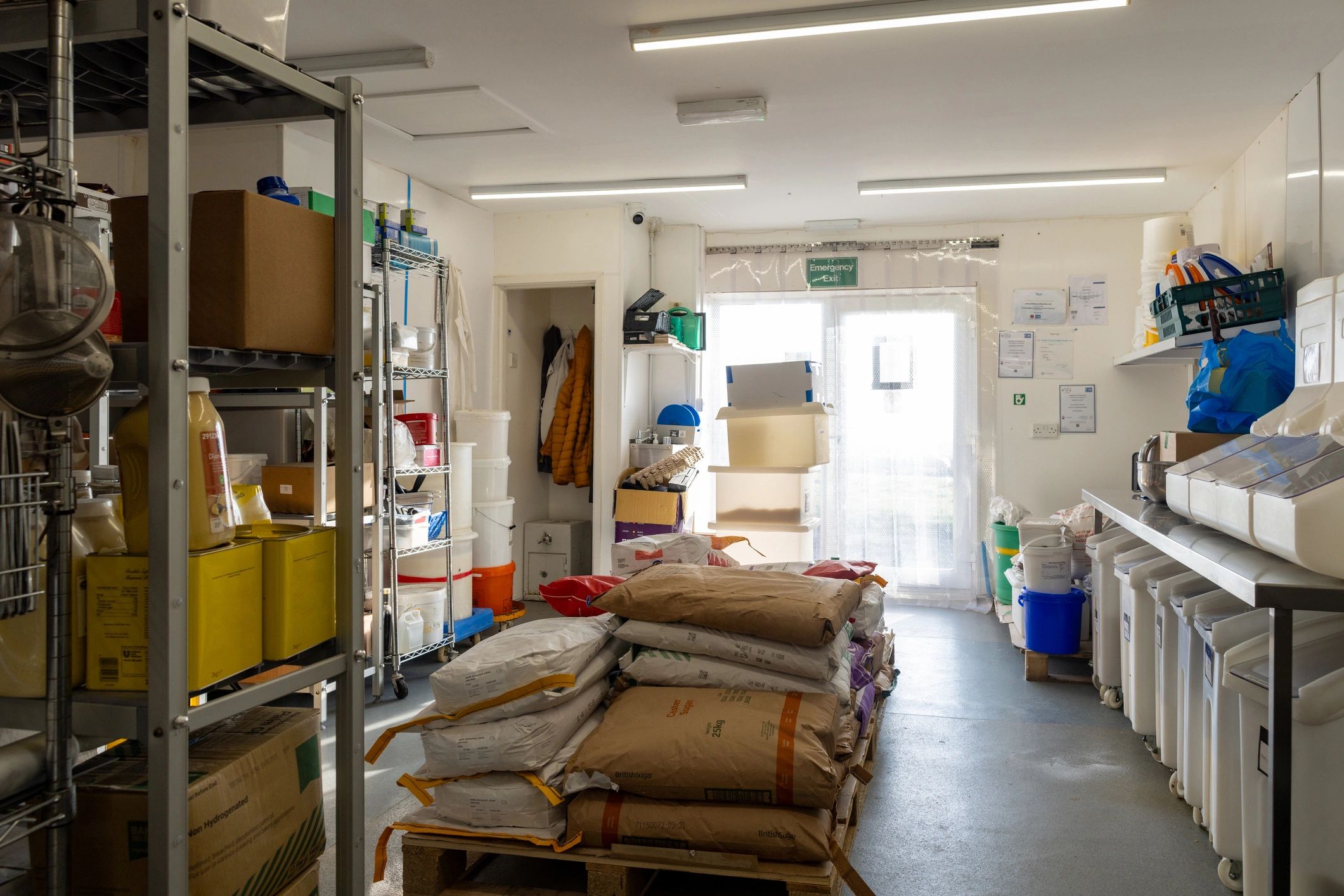 Organized warehouse storage with flour sacks and ingredients ready for distribution